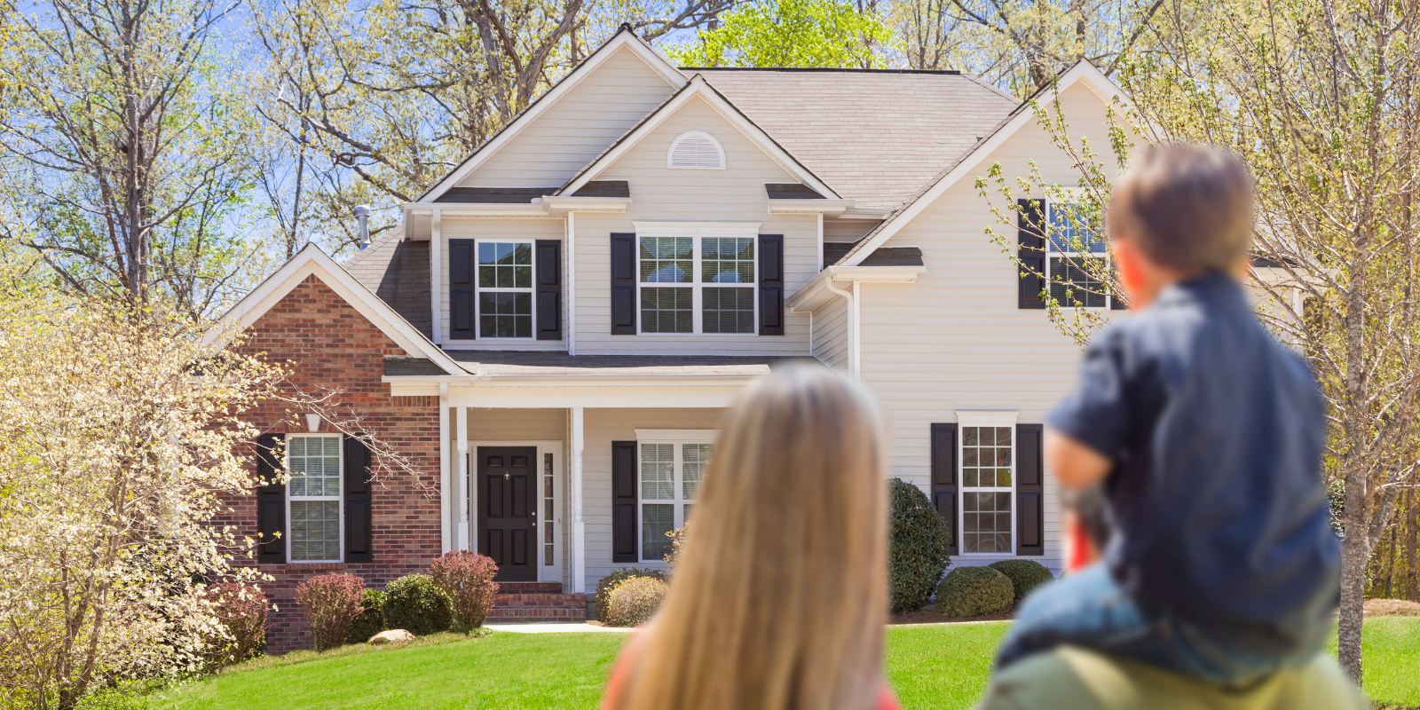 a family standing in front of a house